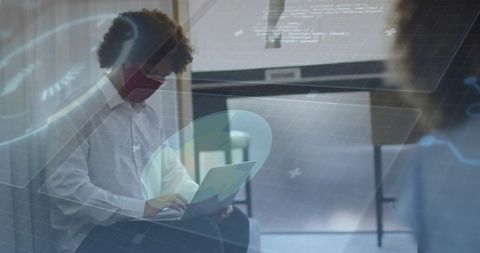 Modern Businessman Working on Laptop with Digital Overlays at Office
