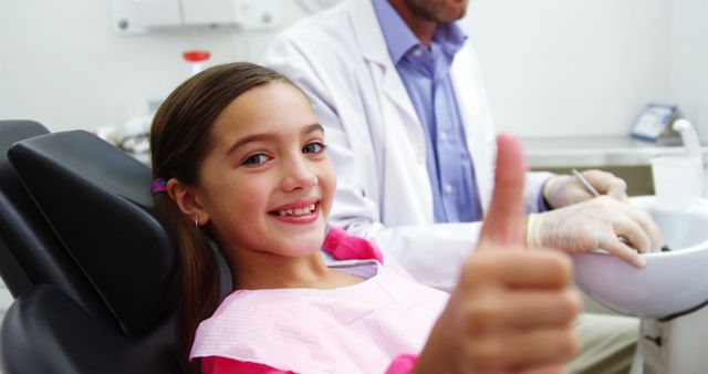 Smiling Young Girl Giving Thumbs Up at Dental Clinic - Download Free Stock Images Pikwizard.com