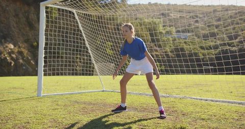Teen Girl as Goalkeeper on Sunny Soccer Field