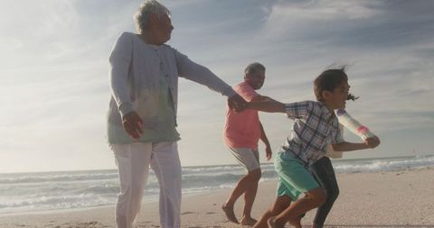Joyful Multigenerational Family Bonding on Beach at Sunset