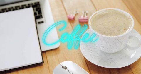 Coffee cup and laptop on wooden workspace with turquoise text overlay
