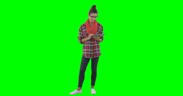 Young woman in plaid shirt and red scarf standing and reading a newspaper on green screen background. Suitable for projects needing isolated figures, educational materials, advertising, or adding custom backgrounds.