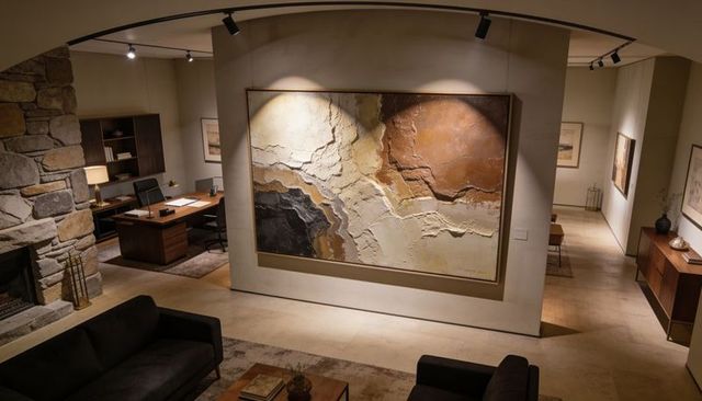 Contemporary living room highlighting large textured abstract painting on partition wall