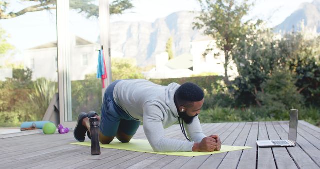 Man Exercising at Home While Watching Fitness Video on Laptop - Download Free Stock Images Pikwizard.com