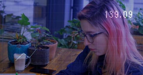 Student Studying in Modern Workspace Surrounded by Plants
