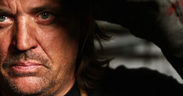 Close-up of Man in Intense Lighting with Rugged Expression - Download Free Stock Images Pikwizard.com