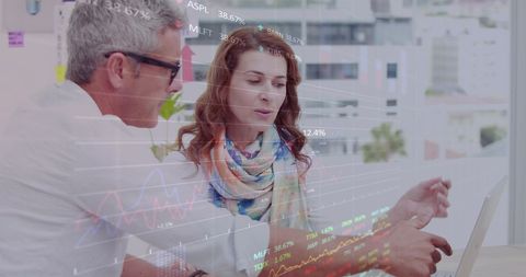 Diverse Business Professionals Analyzing Global Financial Data on Laptop