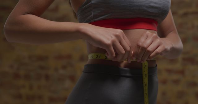 Woman Measuring Waist During Fitness Routine in Sporty Outfit - Download Free Stock Images Pikwizard.com