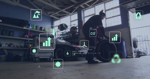 Mechanic lifting tire by sports car in garage with augmented reality telemetry overlays