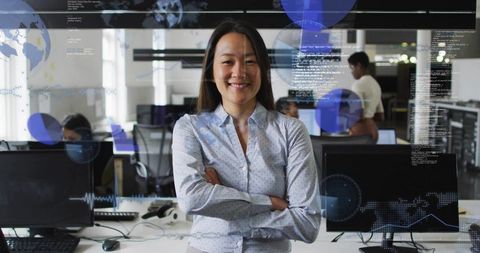 Confident female manager standing arms crossed in tech office with hud data overlays