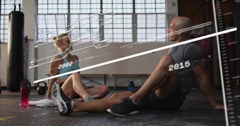 Resting workout partners chatting after training with performance data overlay