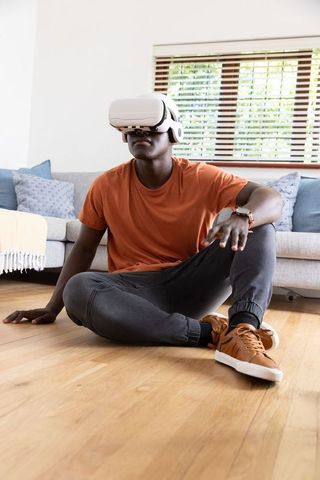 Man Engaged with VR Headset Seated in Contemporary Living Space