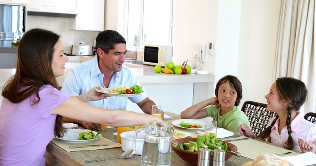 Happy Family Enjoying Healthy Meal Together in Modern Kitchen - Download Free Stock Images Pikwizard.com