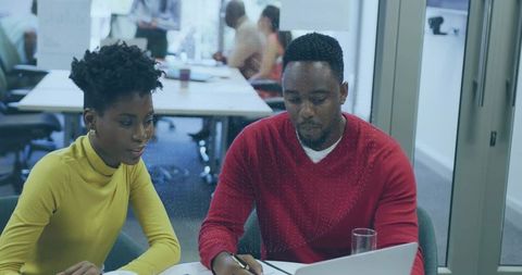 Colleagues Collaborating in Modern Office Meeting Area