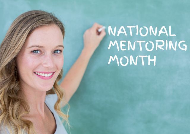 A smiling woman writes 'National Mentoring Month' on a chalkboard. Ideal for use in educational content, mentoring programs, and celebration of National Mentoring Month. Perfect for promoting education, mentorship events, or social media campaigns highlighting the importance of mentoring.