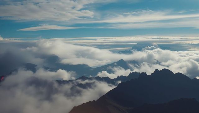 Majestic high alpine mountain ridge in ethereal cloudscape
