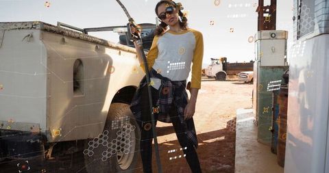Stylish woman refueling utility truck at rural fuel station