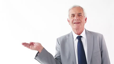 Senior Businessman Gesturing with Open Palm