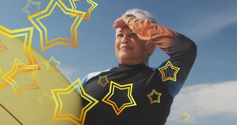 Senior Woman Embraces Adventure with Surfboard in Sunlight