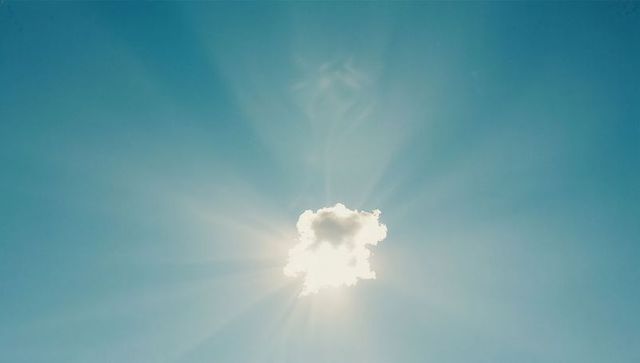 Cumulus Cloud Backlit by Radiant Sunburst