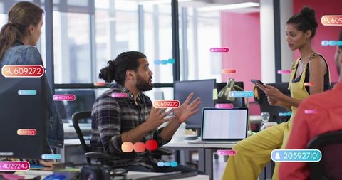 Startup team collaborating in open-plan office with augmented reality tags during meeting