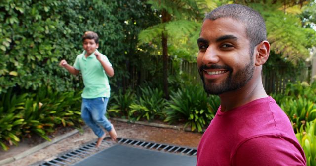 Father and Son Enjoying Outdoor Trampoline Fun - Download Free Stock Images Pikwizard.com