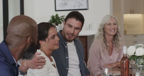 Happy Family Celebrating Wedding at Dining Table with Lively Conversation