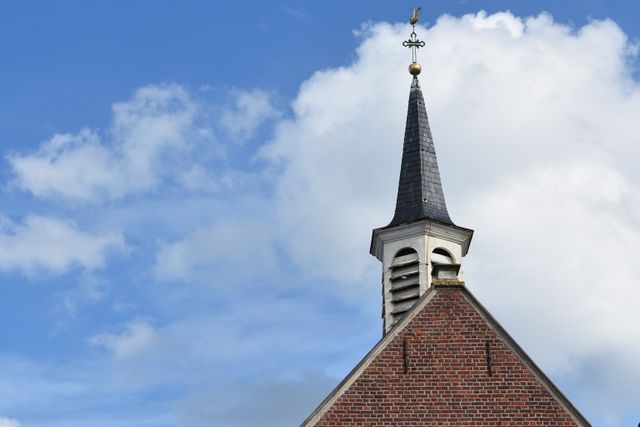 Historic Church Steeple Against Blue Sky with Clouds - Download Free Stock Photos Pikwizard.com
