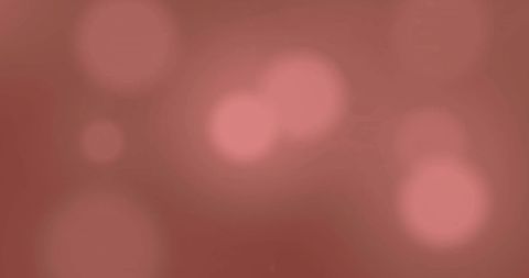 Abstract glowing spots of light on brown background