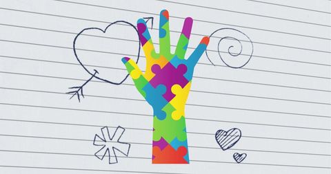Colorful Puzzle Hand Symbolizing Autism Awareness on Ruled Paper - Download Free Stock Images Pikwizard.com