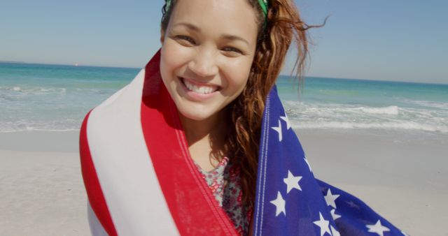 Smiling Woman Wrapped in American Flag on Beach - Download Free Stock Images Pikwizard.com