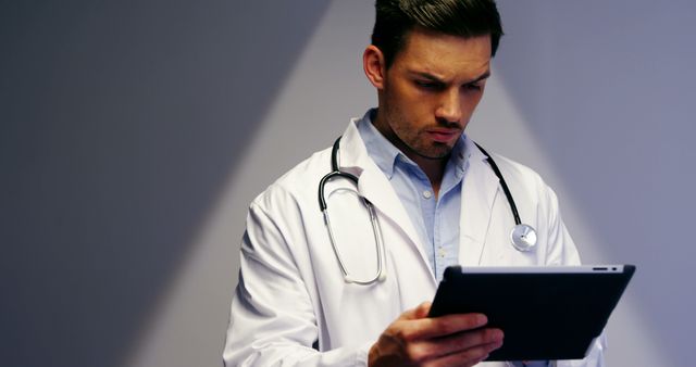 Focused Doctor Reviewing Patient Records on Tablet - Download Free Stock Images Pikwizard.com