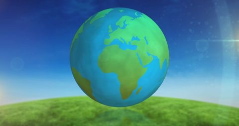 Spinning Globe Over Green Landscape and Blue Sky - Download Free Stock Images Pikwizard.com