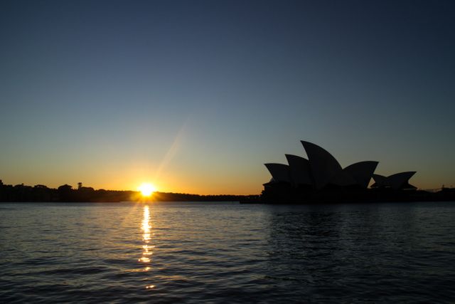 Sydney Opera House at Sunrise Silhouette Over Water - Download Free Stock Photos Pikwizard.com