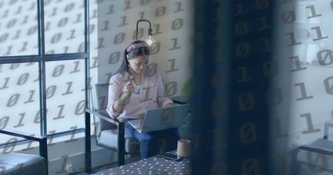 Professional Woman Contemplating Technology in Modern Office Space