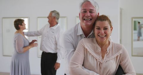 Happy senior couples enjoying ballroom dance class