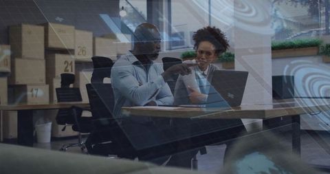 Colleagues analyzing data visualization in modern workspace