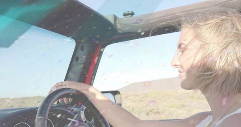 Smiling Woman Driving Convertible on Scenic Road