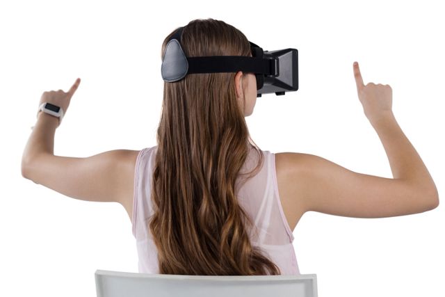 Teenage girl using virtual reality headset against white background