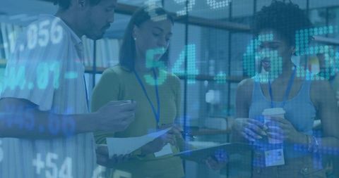 Diverse team reviewing documents and tablet with digital data overlay, planning