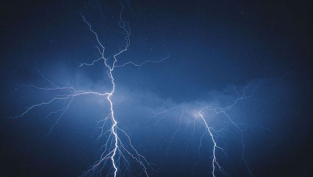 Dynamic Lightning Bolts Exploding Across Night Sky During Storm