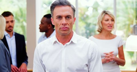 Focused Businessman Amidst Colleagues in Elegant Office Setting