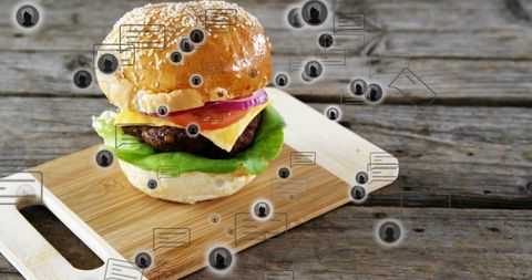 Gourmet cheeseburger on rustic wooden board with social media chat and review icons