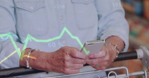 Senior woman holding smartphone in grocery cart viewing mobile analytics overlay 60%