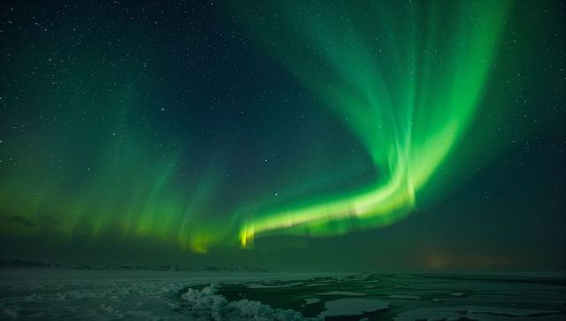 Breathtaking aurora borealis over arctic coastline