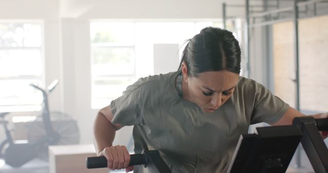 Determined Woman Working Out on Cardio Machine at Gym - Download Free Stock Images Pikwizard.com