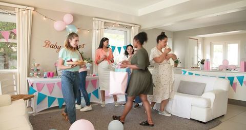 Women Enjoying Baby Shower in Bright Living Room
