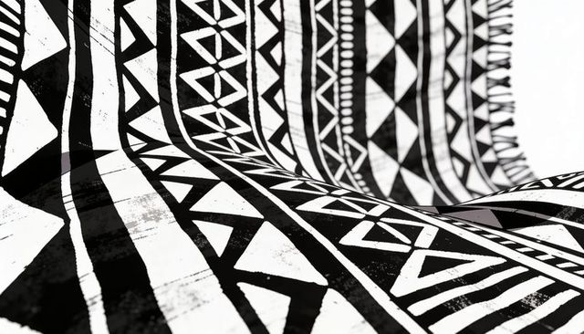 Monochrome tribal geometric textile with bold black print, draped folds and grunge texture