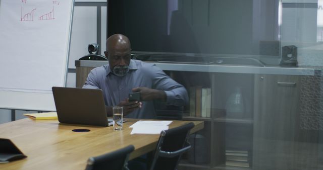 Mature Businessman Checking Phone in Modern Office While Working - Download Free Stock Images Pikwizard.com