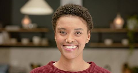 Smiling Young Woman in Modern Kitchen Setting